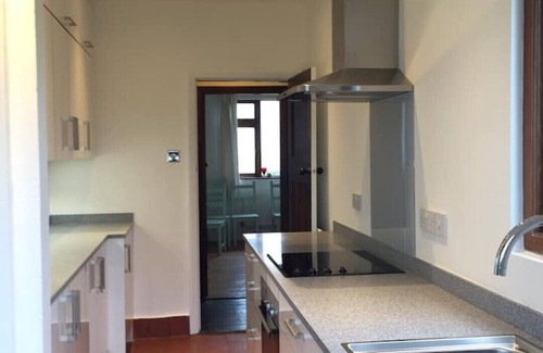 Ty Croes House | 1930's bungalow nr Rhosneigr, opposite beach, large garden and amazing views.