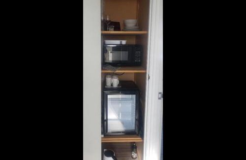 Kawaha Point Apartment | 2 Double Beds, 1 Single Bed, 1 Double Sofa Bed in a small 1 bedroom and 1 lounge Studio No Kitchen Only fridge, microwave
