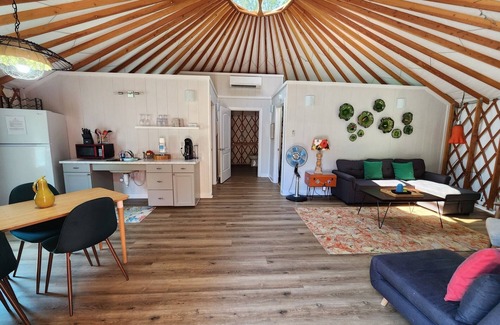 Mill Spring House | 30' ADA Yurt with a large deck, on the creek, full kitchen, dome skylight, dog friendly, 2 bedrooms, sleeps 5.