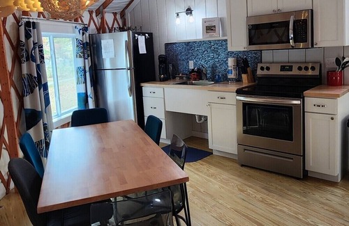 Mill Spring House | 30' Yurt with a large deck, on the creek, full kitchen, dome skylight, 2 bedrooms, sleeps 5.