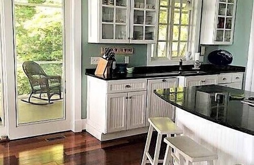 Edgewater House | A huge deck and screen porch on this contemporary cape in Edgewater offers great views of Beard's Creek and out onto the South River.