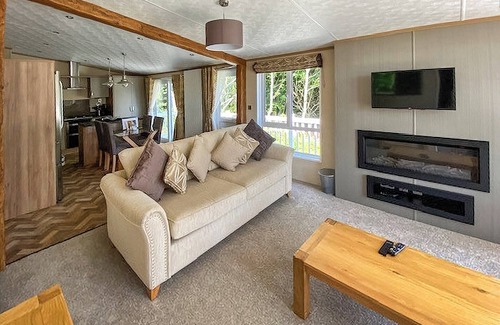 Langham House | A stunning lodge with one master double with en suite with bath and overhead shower.