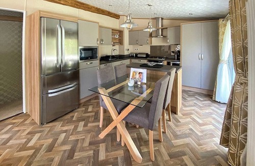 Langham House | A stunning lodge with one master double with en suite with bath and overhead shower.