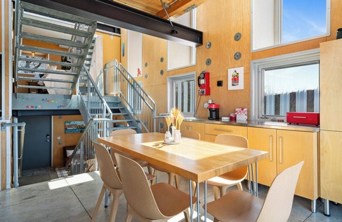 Northport House | Award-winning 9-level Chameleon House in Leelanau County. A modern-industrial masterpiece with reflective siding, rooftop deck, and epic Lake Michigan views near beaches and Fishtown.