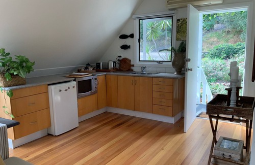 Pretty Beach Apartment | BIRDSONG Stylish private couples loft with water glimpses through the treetops.