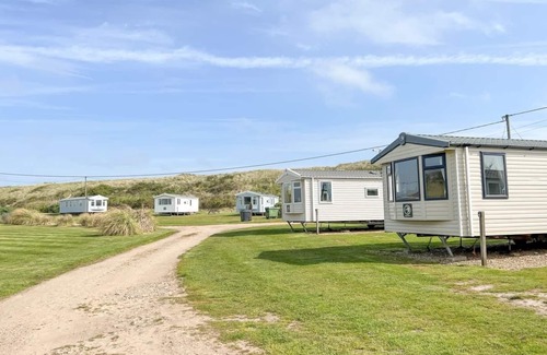 Irstead House | Caravan with one double, twin bedroom and a bunk room.