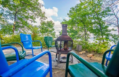 Topinabee Cottage | Charming lakefront cottage with large yard, dock, & fire pit - close to downtown