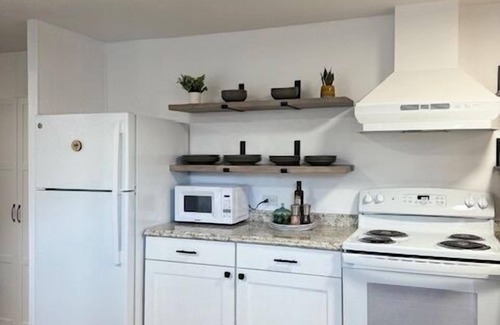 Rock Springs House | Completely Renovated home comfortably accommodates your stay with a queen bed in the primary bedroom, a twin bed with a pull-out trundle in the second bedroom, and a sleeper sofa in the living room for additional guests.