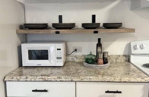 Rock Springs House | Completely Renovated home comfortably accommodates your stay with a queen bed in the primary bedroom, a twin bed with a pull-out trundle in the second bedroom, and a sleeper sofa in the living room for additional guests.