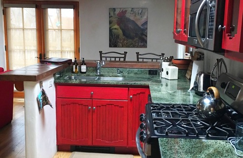 Taos Condo | Cozy Casa Carmelita features a Brilliant Kiva Fireplace, Unique Patio & Hot Tub!