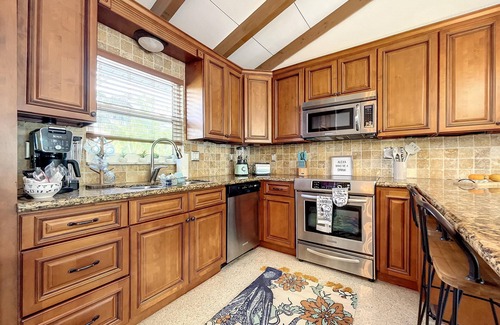 Whitney Beach House | Cute canal front Cottage with dock & boat lift and pool ,short walk to the beach