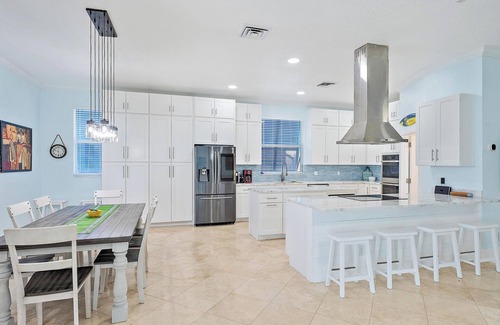 Palm City House | Deep water front home with private dock, pool, outdoor kitchen and pool table.