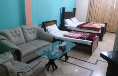 G-8 Sector House | Deluxe room with extra single bed
