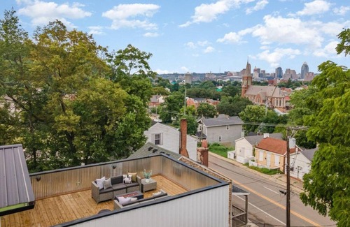 Covington House | Downtown skyline view featuring giant rooftop deck & wet bar with a city view.