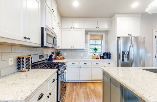 Rogers House | Elegant lakefront home with a fireplace, screened patio & lovely views