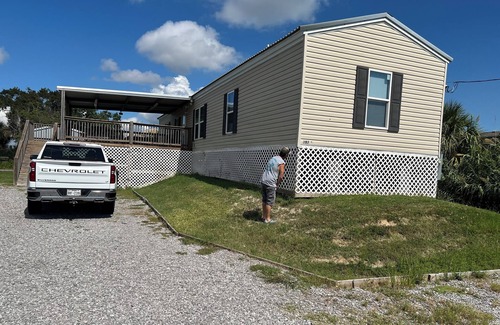 Hackberry House | Fishing camp with boat stall cleaning table three bedroom two bath