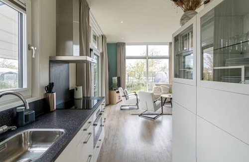 Burgh-Haamstede House | Garden-oriented, bright living room with an adjoining (electrically operated) patio cover Lush garde