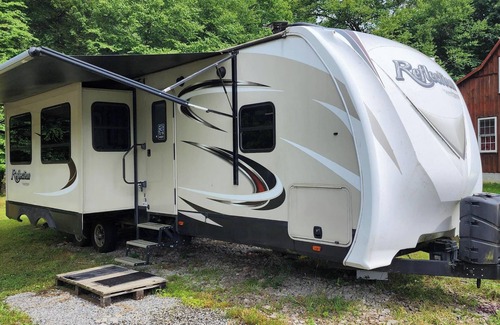 Helvetia RV Rental | Glarus - Riverside 36' RV, trout stream firepit