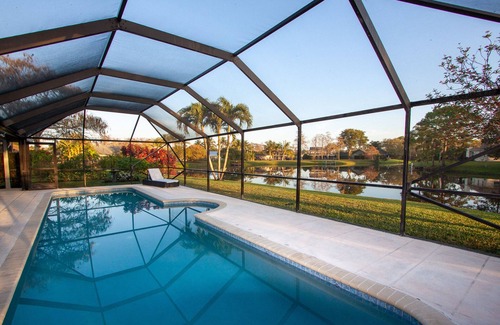 Wellington House | Golf cart distance to WEF! Charming 3 bedroom waterfront home with heated pool.