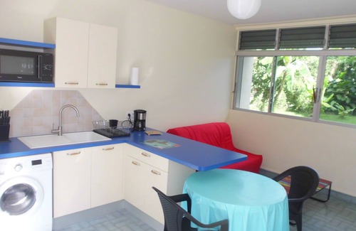 Saint-Claude House | Kitchen-living room and air-conditioned bedroom, at the foot of La Soufrière.