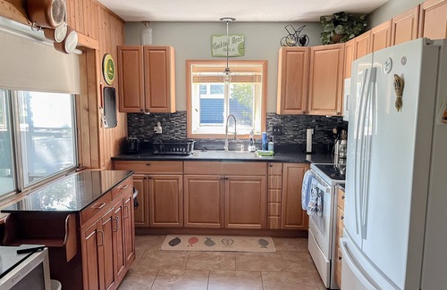 Mecosta Cottage | Lakefront Retreat | Hot Tub, Firepit, Kayaks, Dock & Spacious Outdoor Living