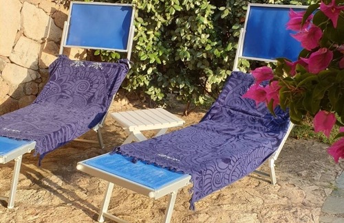 Baja Sardinia Apartment | Large and beautiful master bedroom with bathroom within walking distance of the sea.