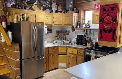 Dawson City House | Log cabin with large deck and 6 person hot tub