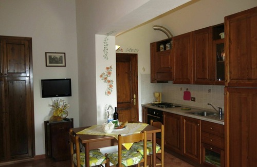 Lajatico Villa | Lovely apartment in villa for 2 guests with pool, WIFI, TV and patio