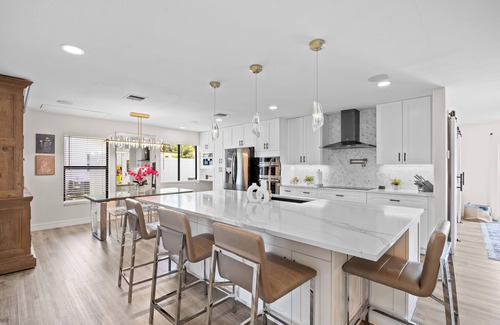 Tropic Palms House | Luxe Coastal Retreat - 4BR w/Pool, Hot Tub, Arcade & Work Space - 3 mi to beach