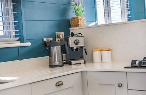 Middlezoy Ski Chalet | Luxurious lodge with vaulted ceilings and a welcoming feature fireplace.