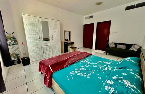 Al Majaz House | Luxury Awaits: Master Bedroom for Rent! Indulge in comfort and style.