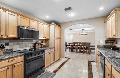 Lake Worth House | Luxury Lakefront Retreat with Heated Pool, Tiki Lounge, Dock, Gym & EV Charger