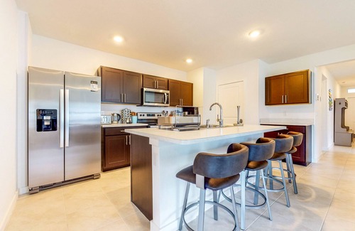Stuart House | Modern Treasure Coast home with Peloton, EV charger, tennis, patio, & central AC
