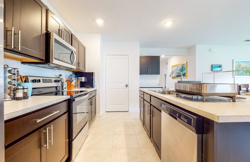 Stuart House | Modern Treasure Coast home with Peloton, EV charger, tennis, patio, & central AC