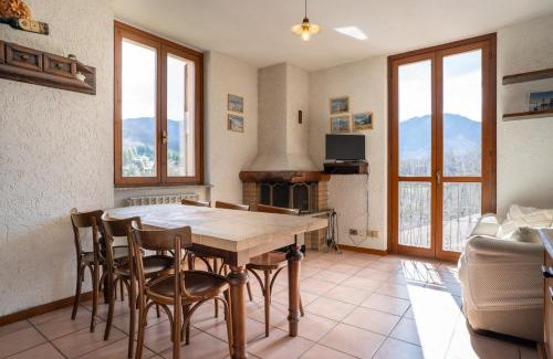 Barzio Apartment | Mountain lodging with fireplace and mountain view