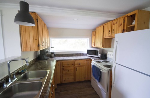 Yarmouth County House | Ocean cottage nestled amongst tall oak trees, pet friendly.