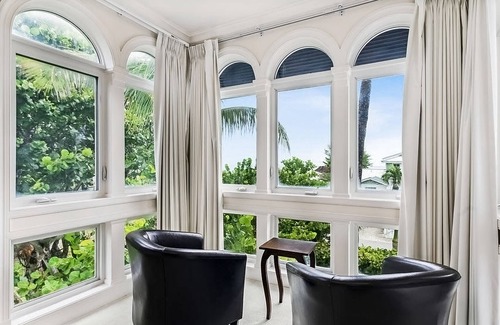 Ocean Ridge House | Ocean view estate w/in ground outdoor pool, breezy terraces, and covered lanai