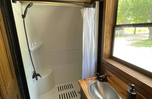 Branson Cottage | Oregon Trail Wagon has two queens size bed, bathroom w/shower, heat & a/c, smart tv, wi-fi, microwa