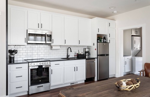 Bellaire Apartment | Pet-Friendly 2BR Family Suite in Boutique Resort w/Hot Tubs, Sauna, & Fire Pit!