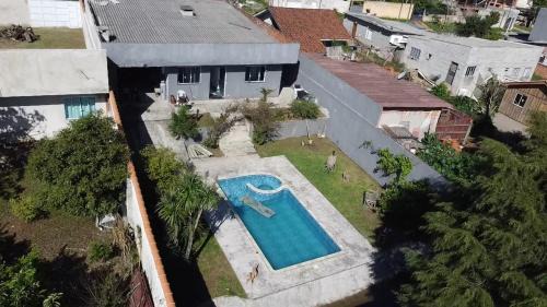 Piraquara House | Por do sol piscina e skate e churrasco