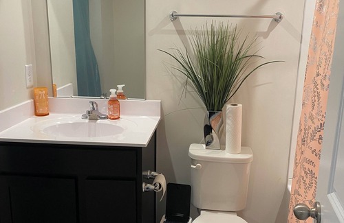 Milford House | Primary bedroom and private bathroom space. Shared kitchen and dining area