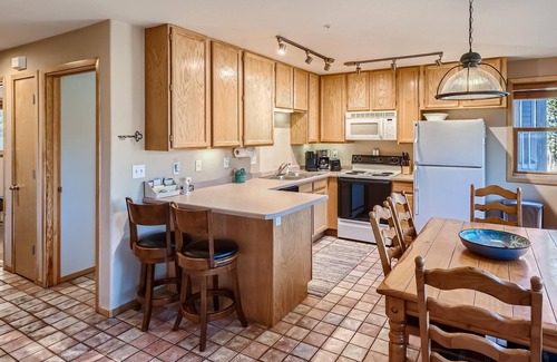 Wildernest Condo | Relax on the Deck with Red Mountain Views. Centrally Located Near Skiing, Trails, Dining & More!