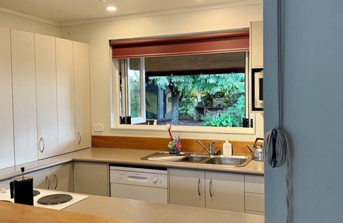 Broadlands Forest House | Riverside accommodation which is perfect for groups. Pizza oven, covered deck.