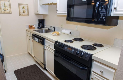 Estes Park Condo | Suite features King bed, full kitchen, and deck with a river view.