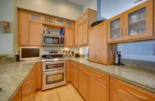 Marina Peninsula Condo | Sunsets and sweeping views, sliding doors open to the sand