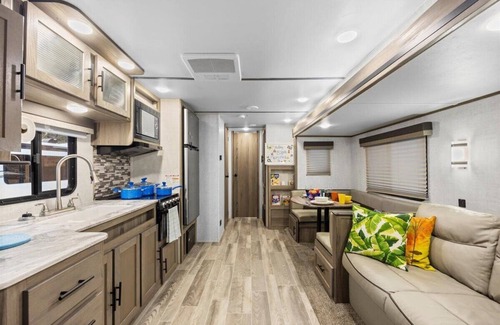 Milton RV Rental | Super- fun camper with plenty of room for a full-size family, lots of comfy beds + full kitchen, bath, and separate bedroom for Mom & Dad. There's even a nice patio with outdoor kitchen and seating area for barbecues, bacon & eggs in the morning, et