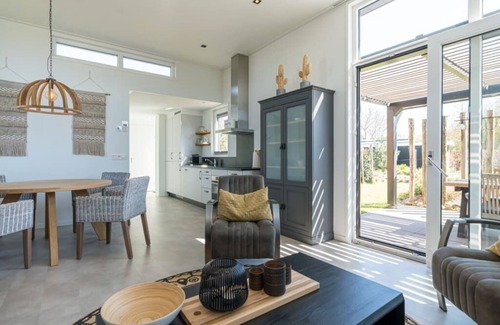 Burgh-Haamstede House | This chalet is beautifully finished both inside and outside. The landscaping, canopy, poster walls a