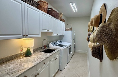 Longshore Lake House | Tropical Retreat - pet friendly 3 bedroom 3 bath home with pool and hot tub.