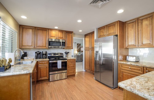 Tami Estates House | Unbeatable location, fun game room, relaxing heated pool and spa, putting green!