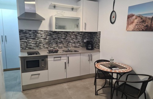 Playa de Arinaga Apartment | Vacation 'Casa Paula - 12' with Mountain View, Shared Pool and Wi-Fi